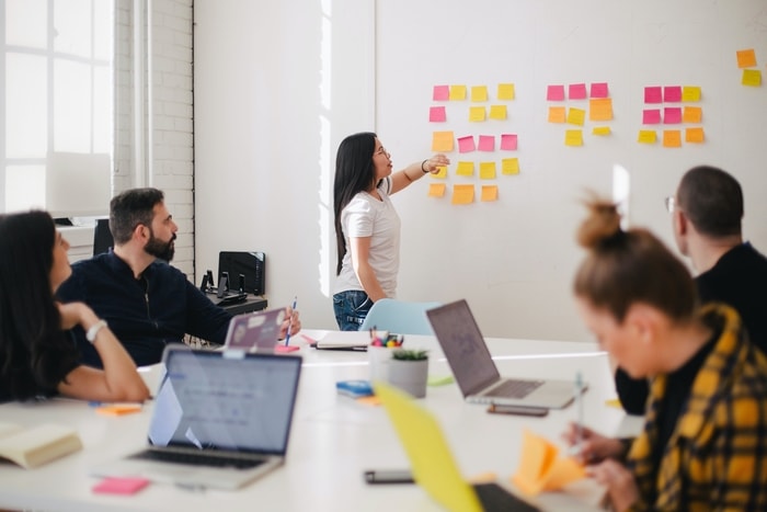 Employees meet in a conference room to cover drug-free workplace policy